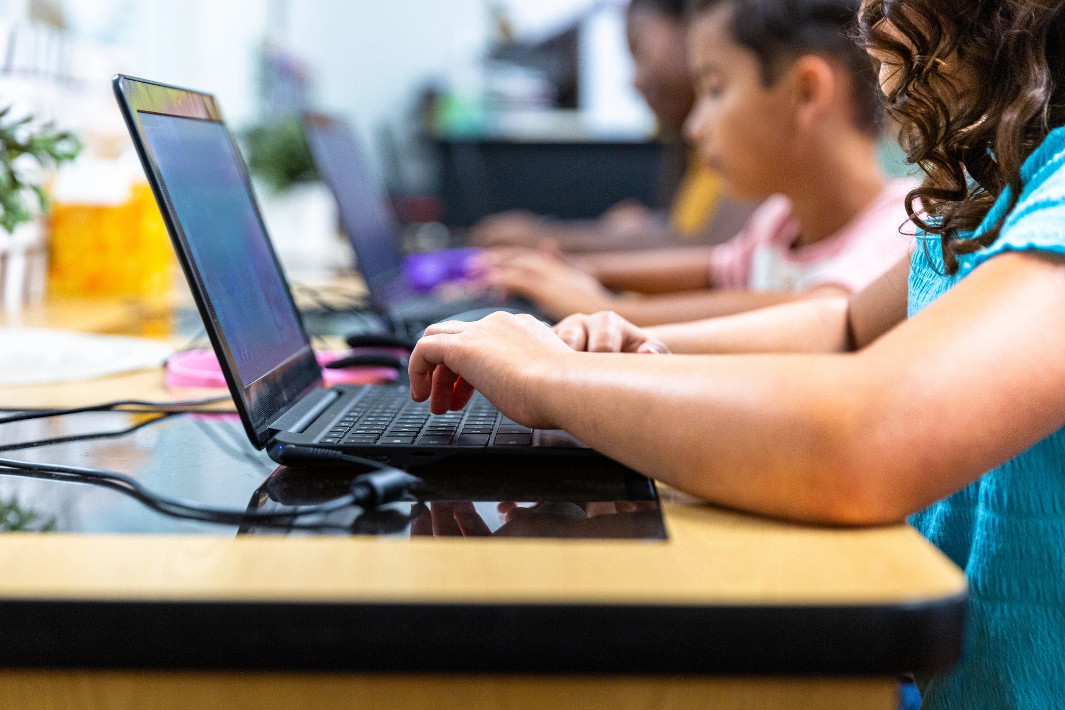 children at school on laptops